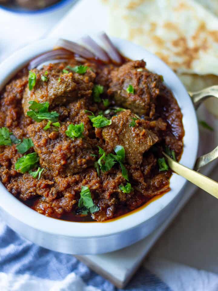 a small pot with tamatar gosht