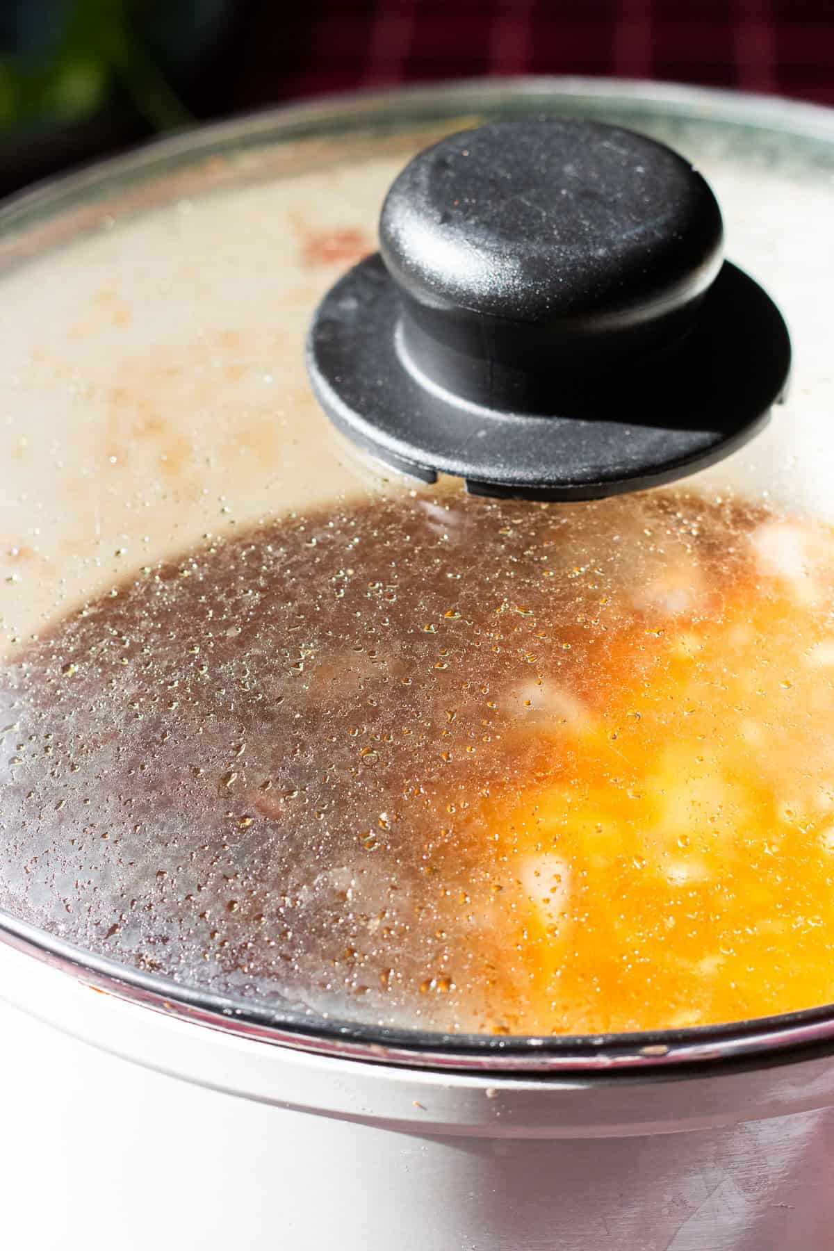 meat curry simmering in a covered pot. 