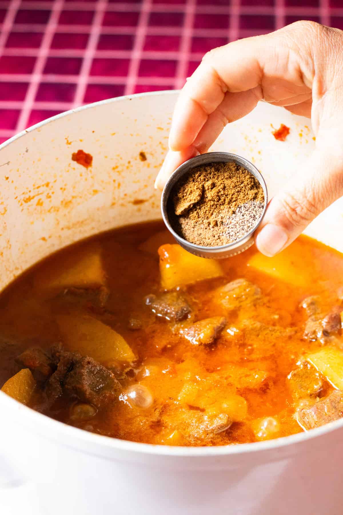spices in a lid, about to be added to a curry.
