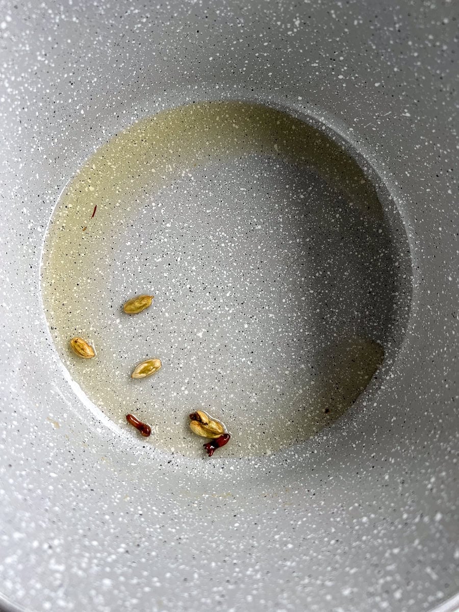 heating spices in a pot, top down view