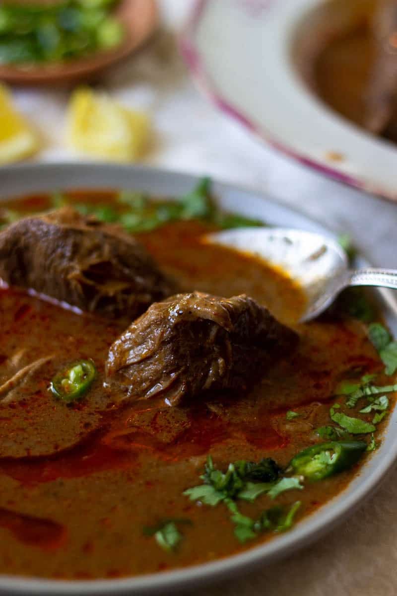 a bowl of nihari with a spoon in it