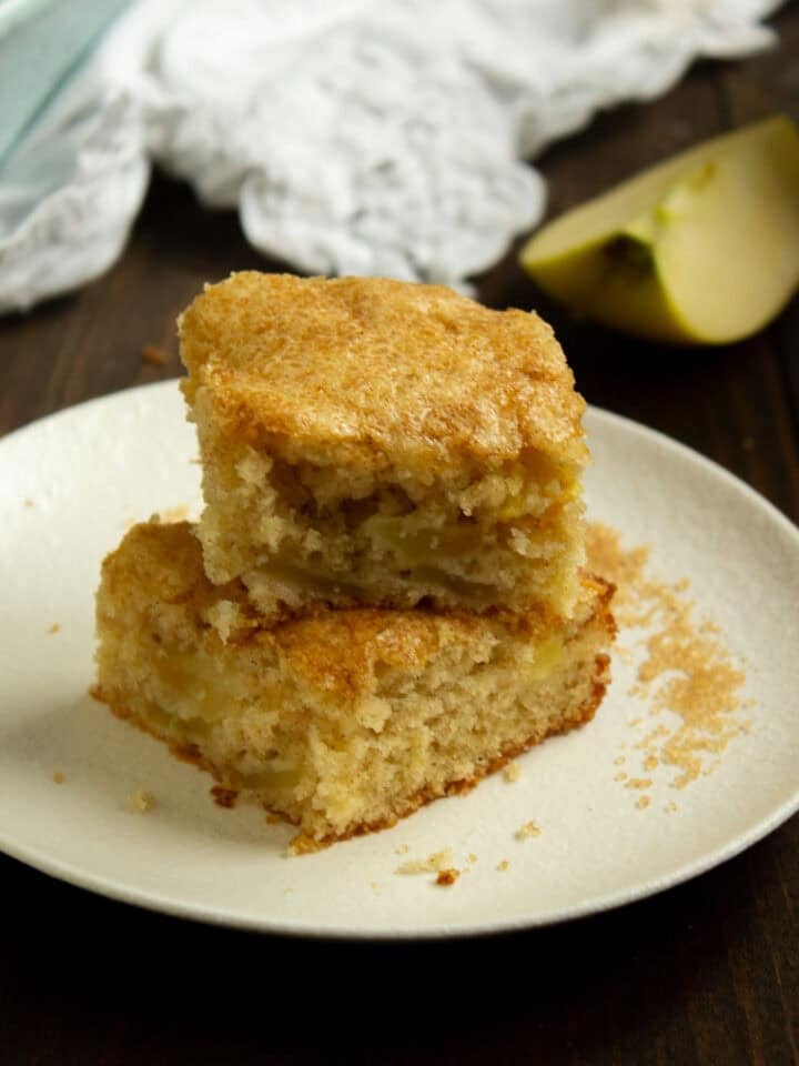 Two pieces of Apple Cake stacked on a plate