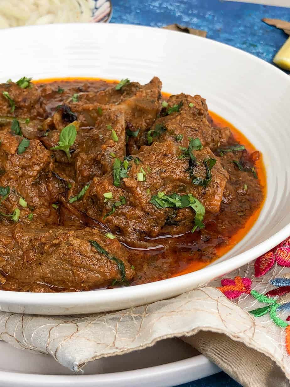 Mutton Handi in a bowl, fabric underneath