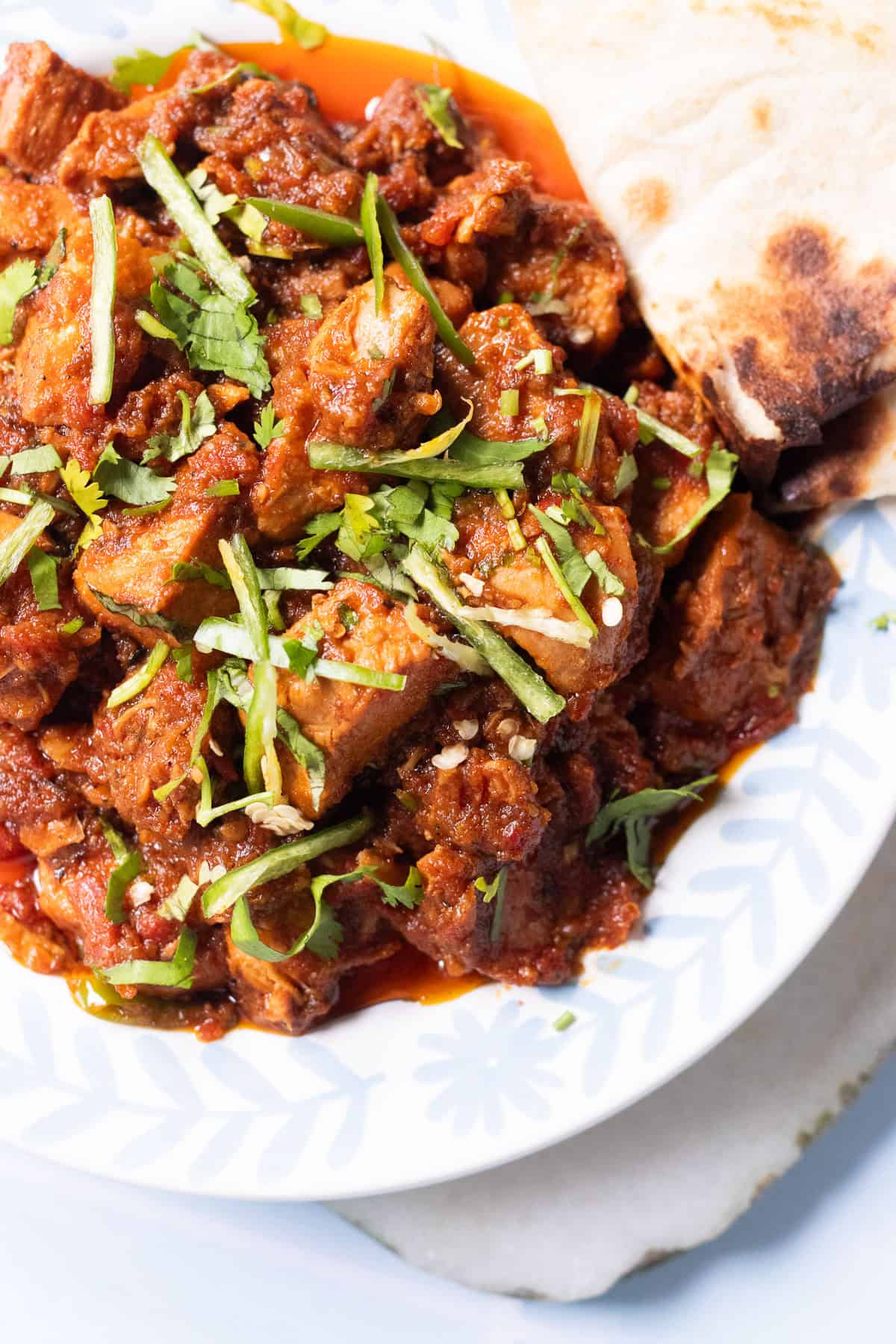 chicken masala garnished with julienned green chilies and chopped coriander