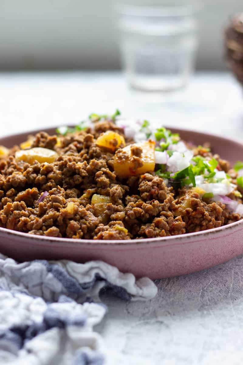 A pink dish with Aloo Keema in it 