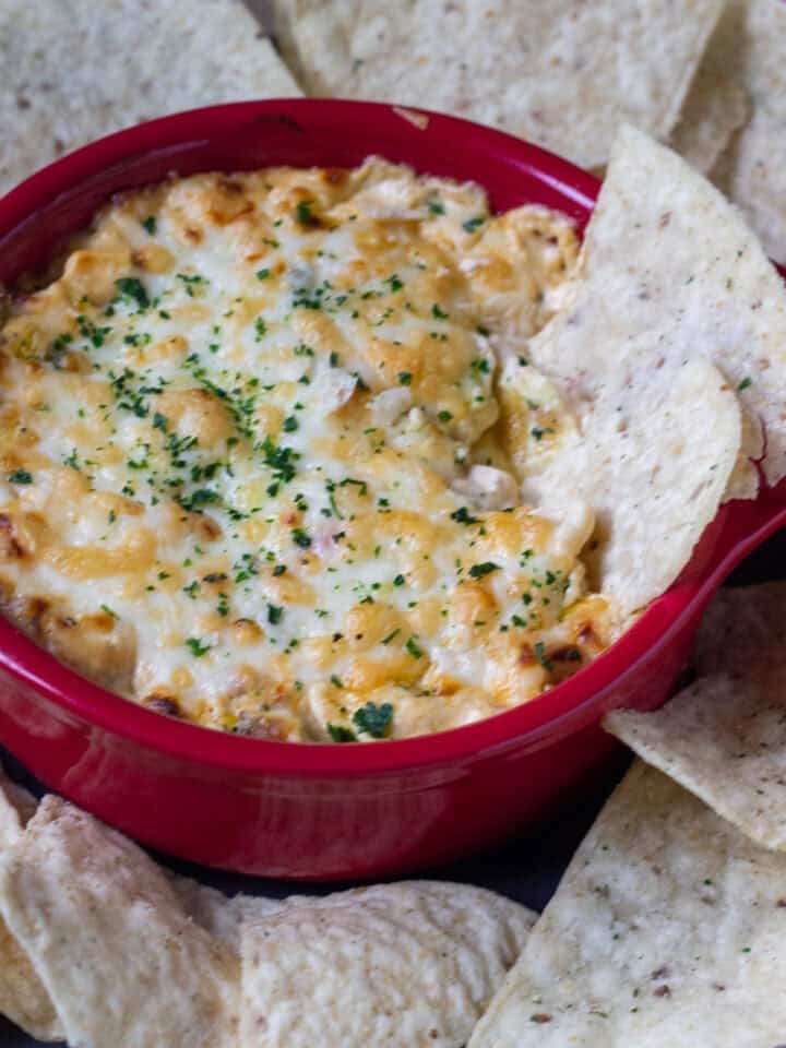 cajun corn dip with chips dipped halfway