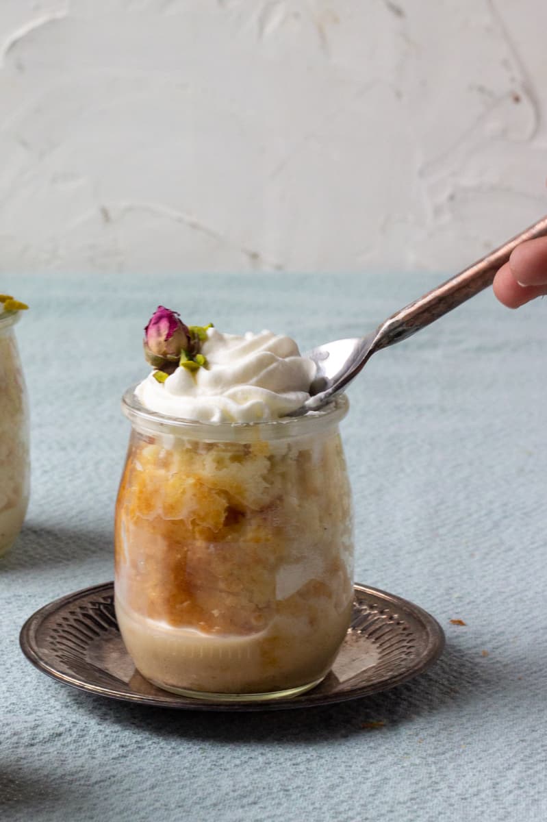 Ras Malai Tres Leches Cake with a spoon in it