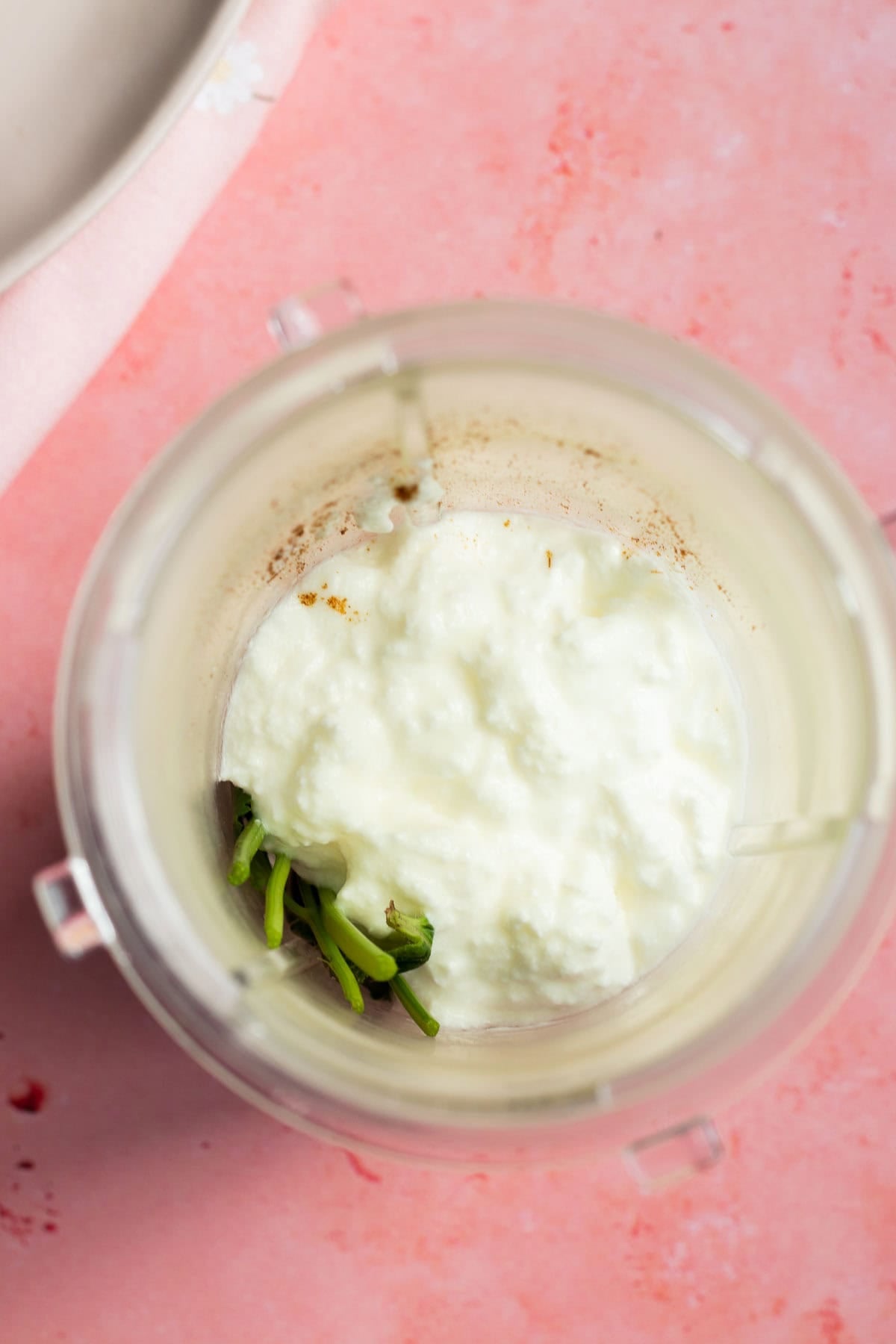 blender with green raita ingredients