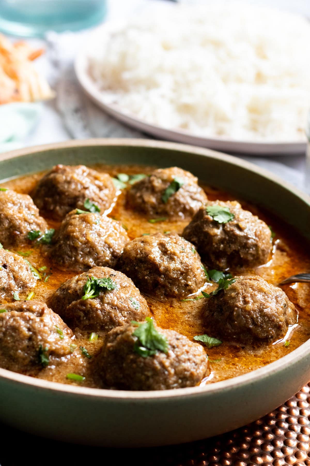 A dish of Kofta Curry garnished with cilantro
