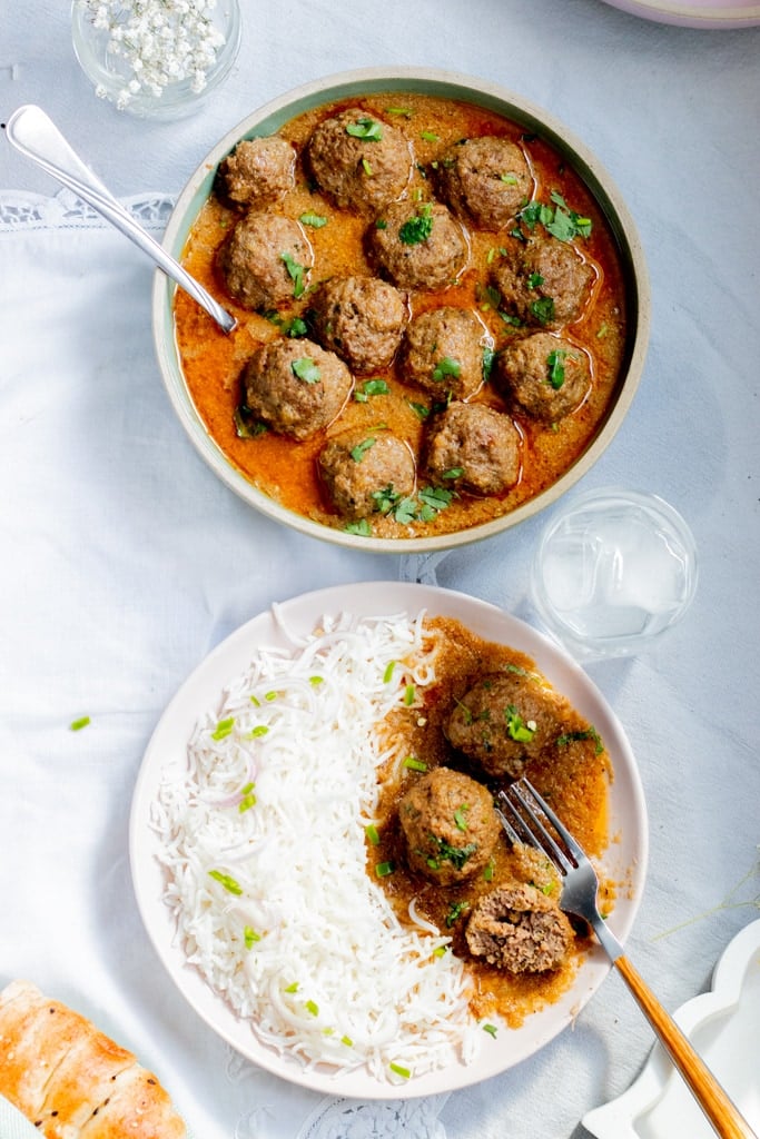top down view of two dishes - one of koftay and rice and one of just koftay in salan