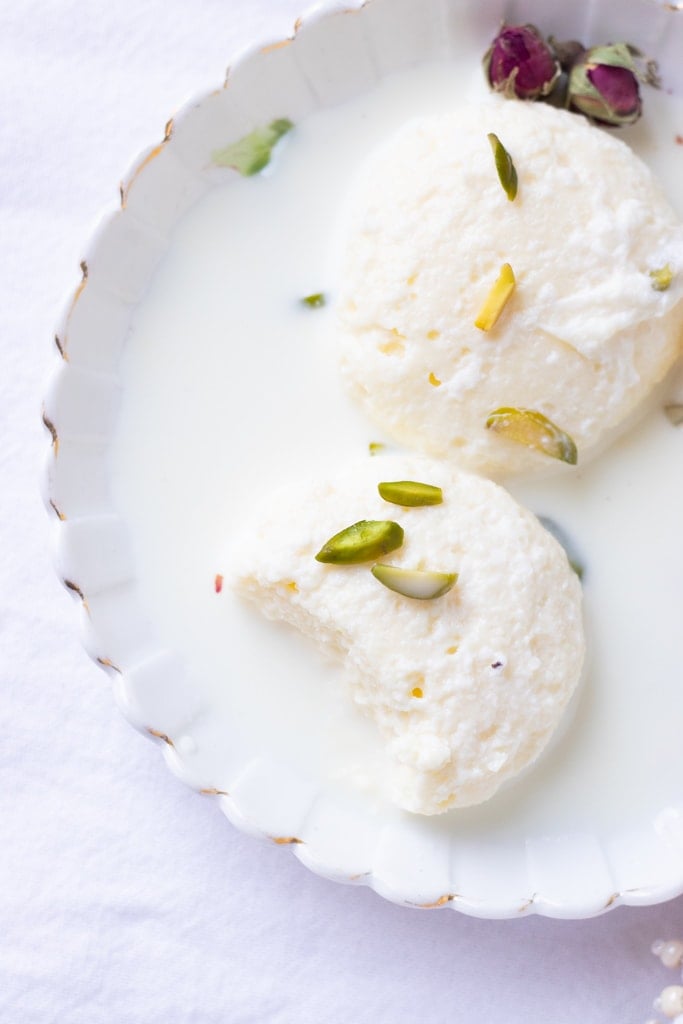 partial view of a small plate of ras malai,a bite taken out 