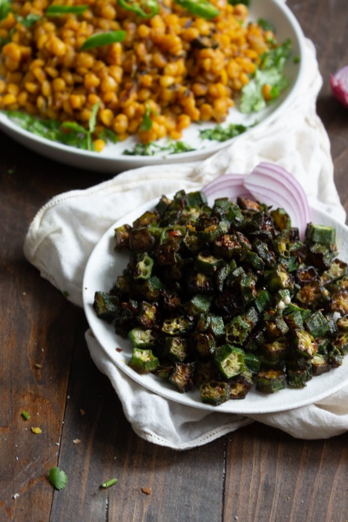 bhindi ki sabzi in a dish, daal in the background 