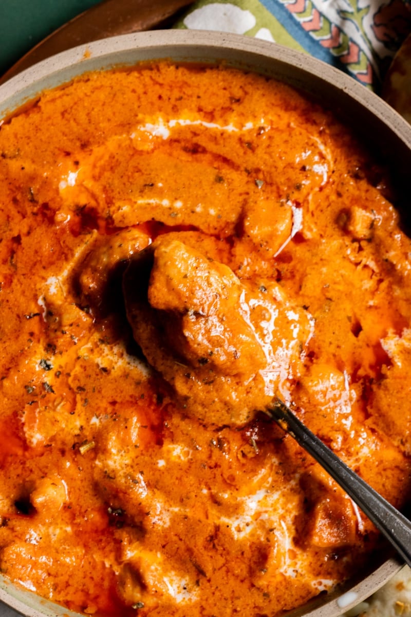 Close up of a dish of Chicken Handi with a spoon in it