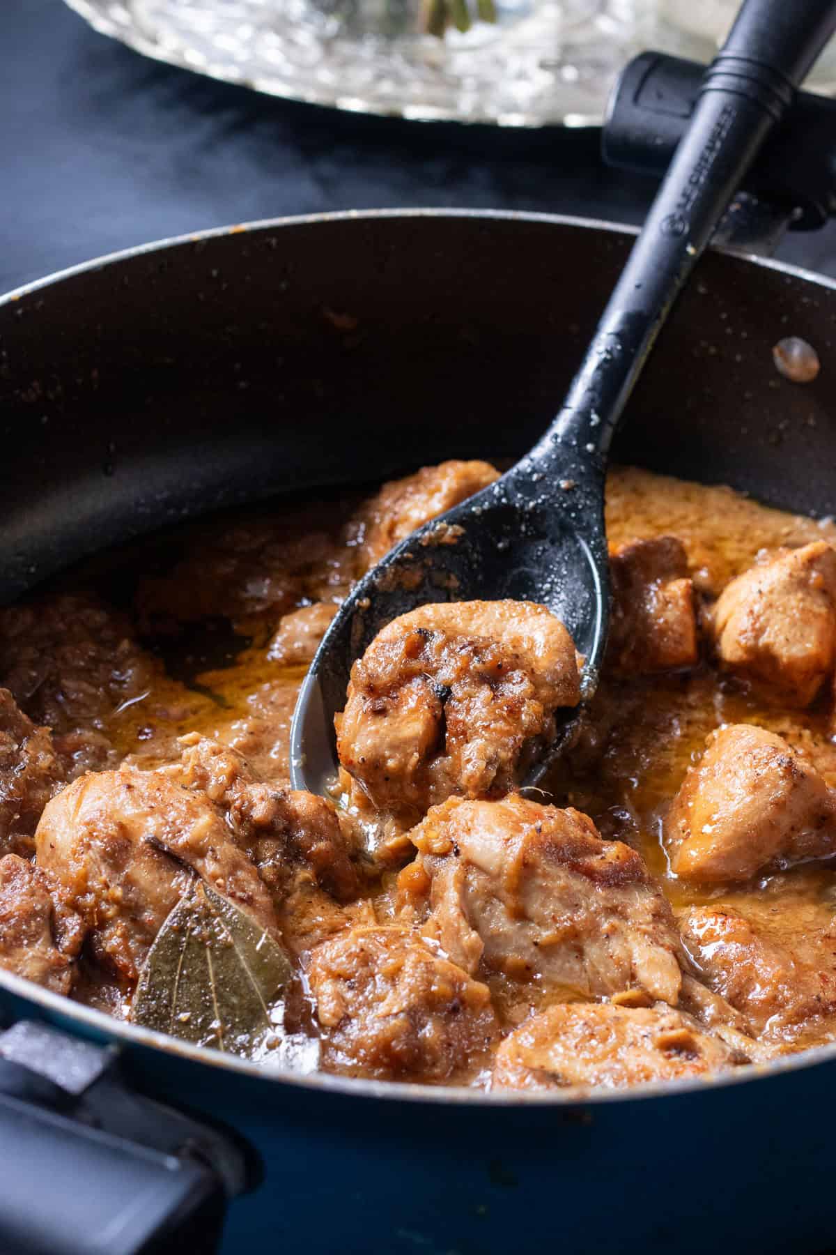 prepared korma
in the pot with a spoon