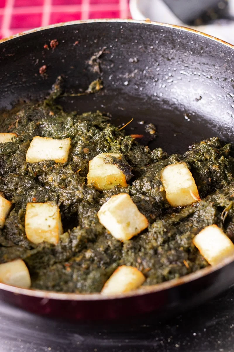 paneer in a wok with the palak paneer base