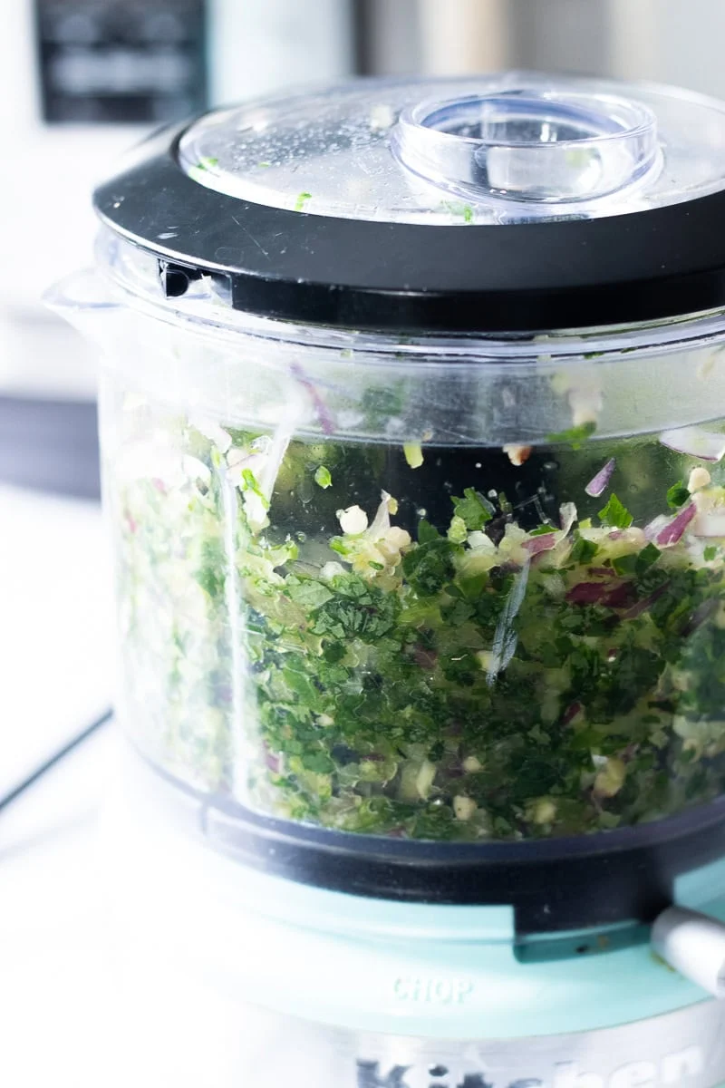 minced onions and herbs for chicken shami kebob in a mini food processor